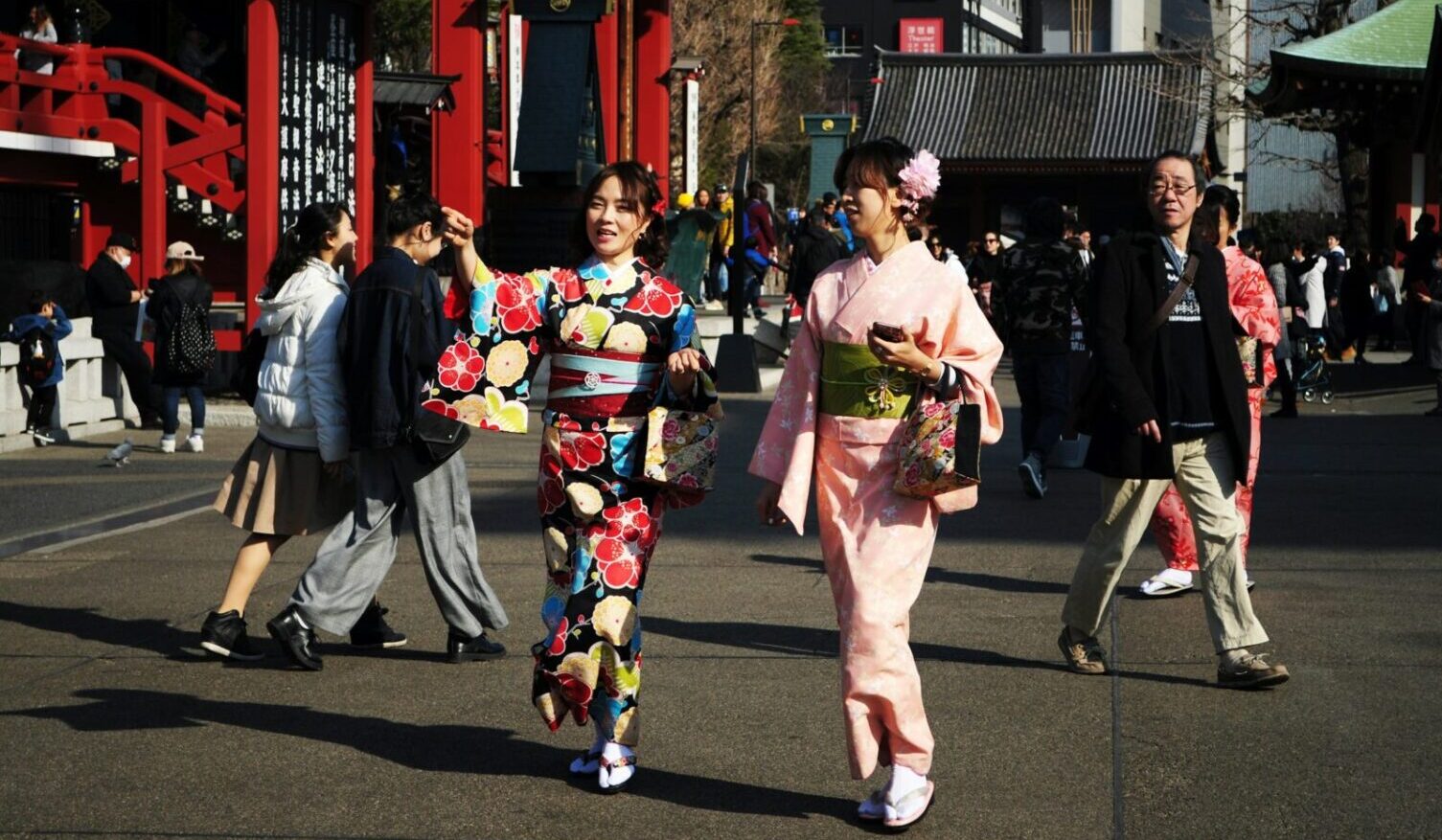 Women dressed in traditional clothing walking down the pavement in Asakusa Tokyo. Photo by Maria Cassagne