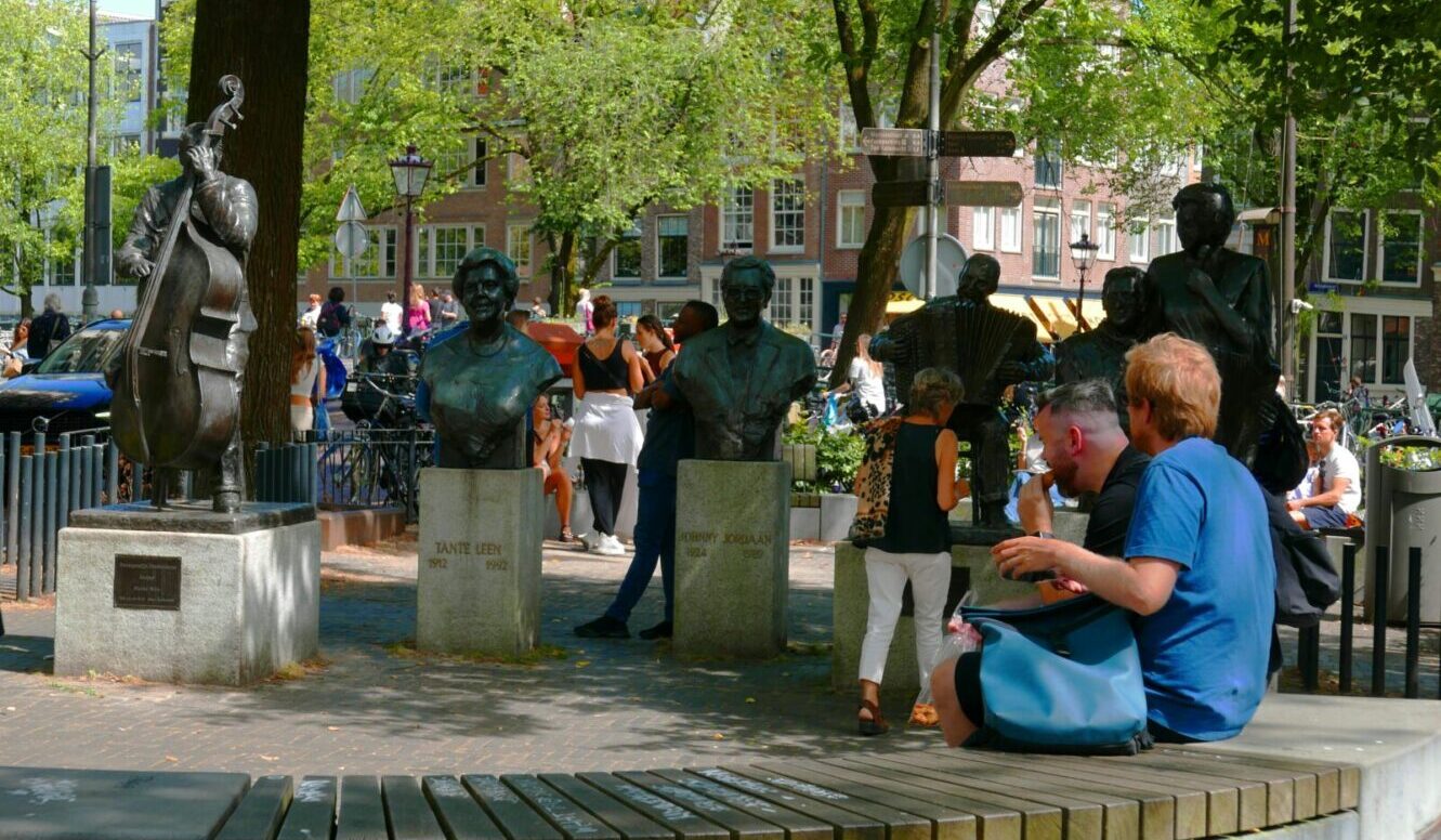 The Netherlands People outside on benches Elandsgracht Amsterdam Fons Heijnsbroek