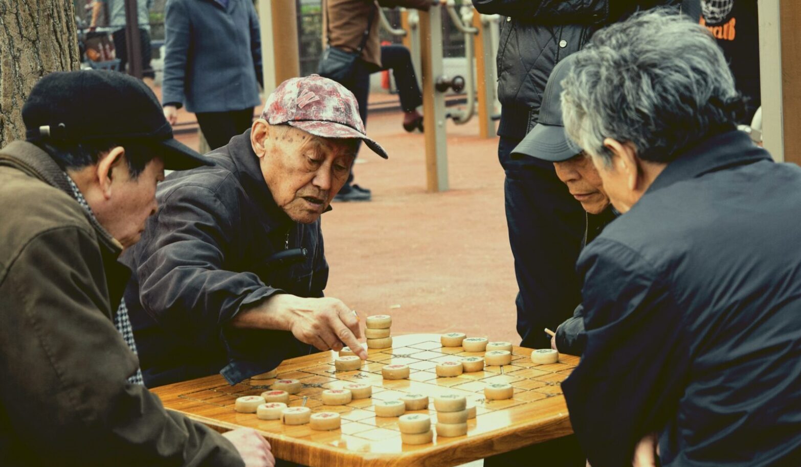 Seniors playing Chinese chess on the street in Beijing. Photo by Woody Yan