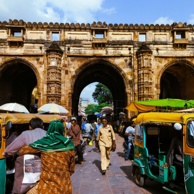 Gujarat People and autorickshaws moving through Teen Darwaza an historical gateway on Gandhi Road, Old City, Bhadra, Ahmedabad Aby Zachariah